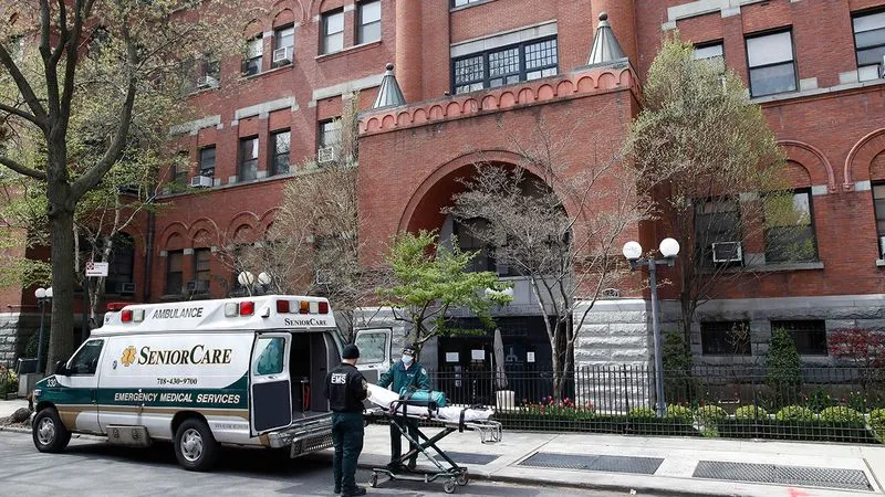 view of an apartment with an ambulance in front of it with a patient