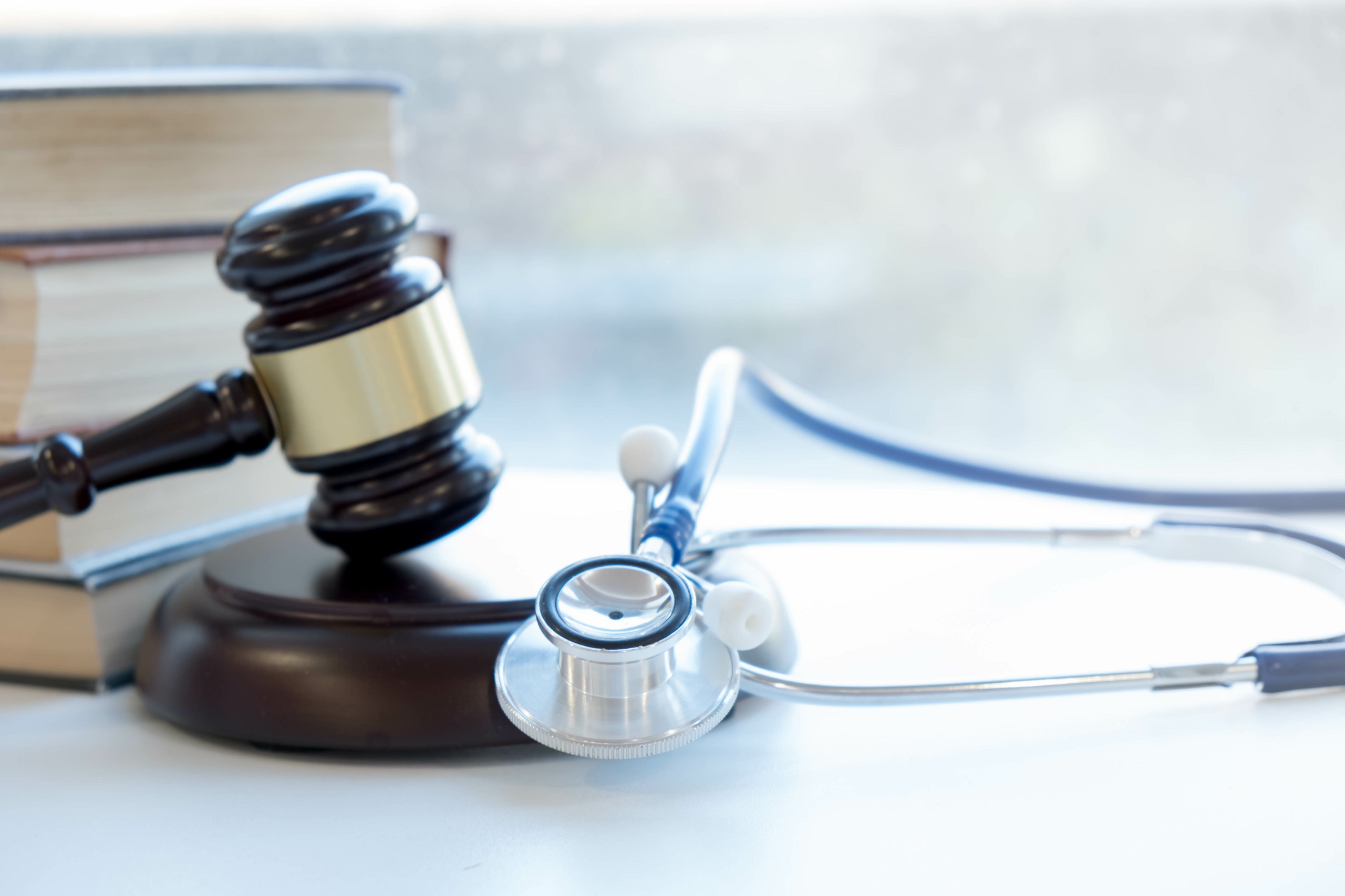 gavel and stethoscope on a table