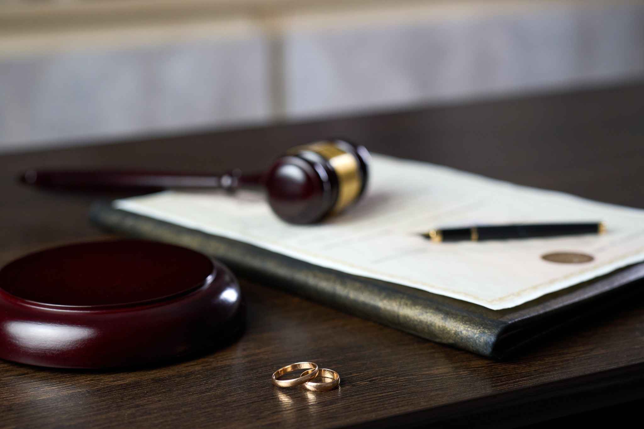 gavel and wedding ring on table