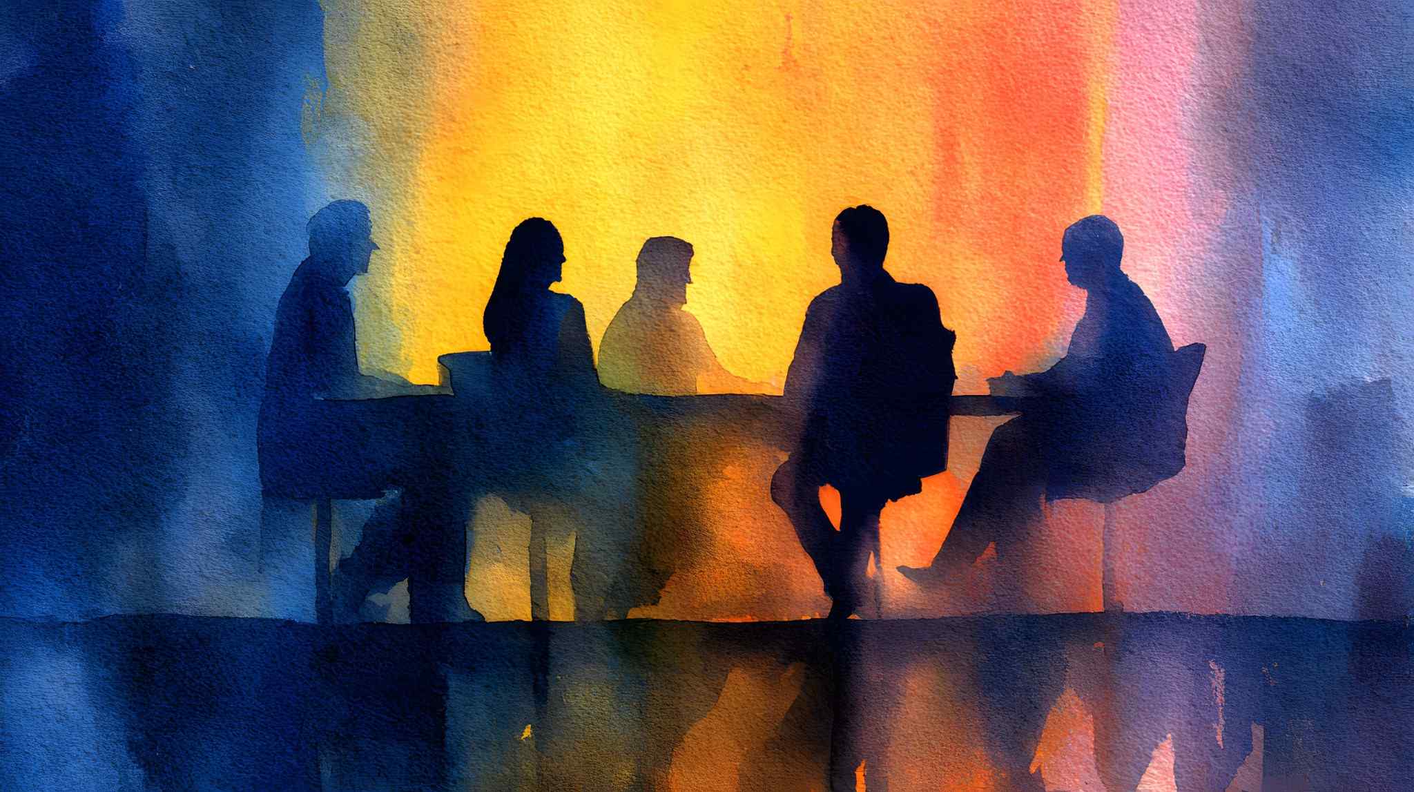 business people in shadow at table with color behind