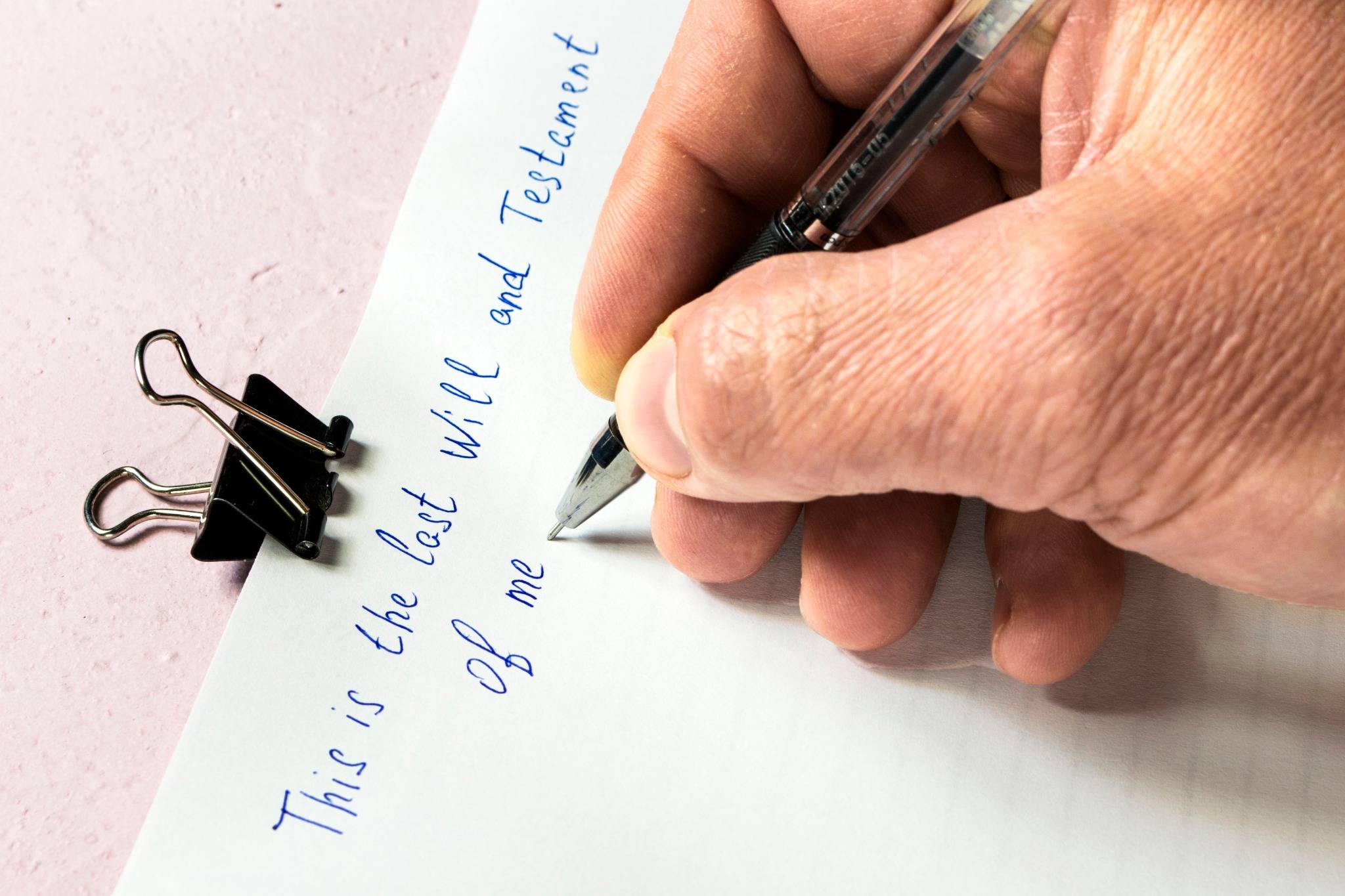 person writing their last will and testament