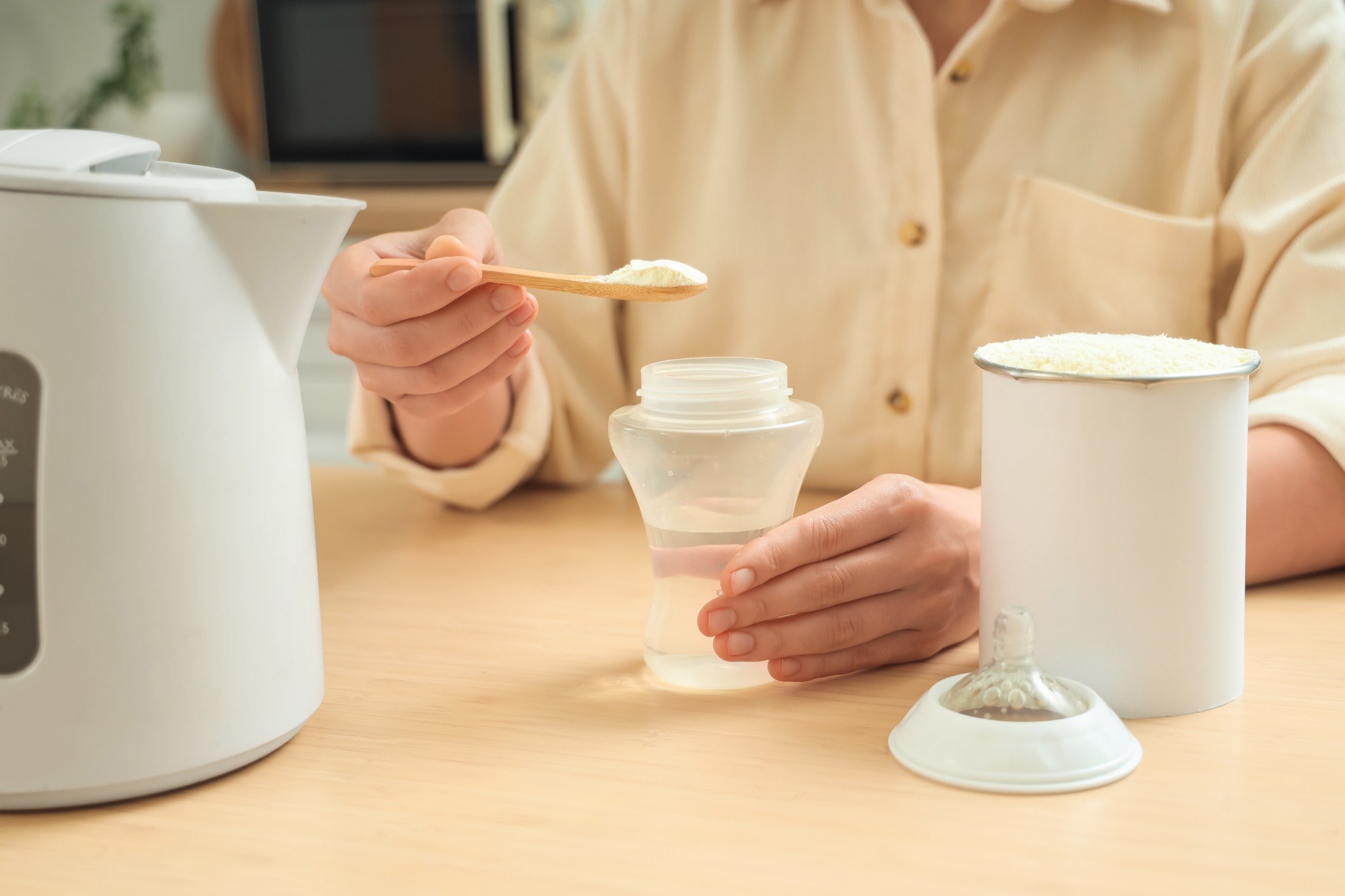woman scooping baby formula