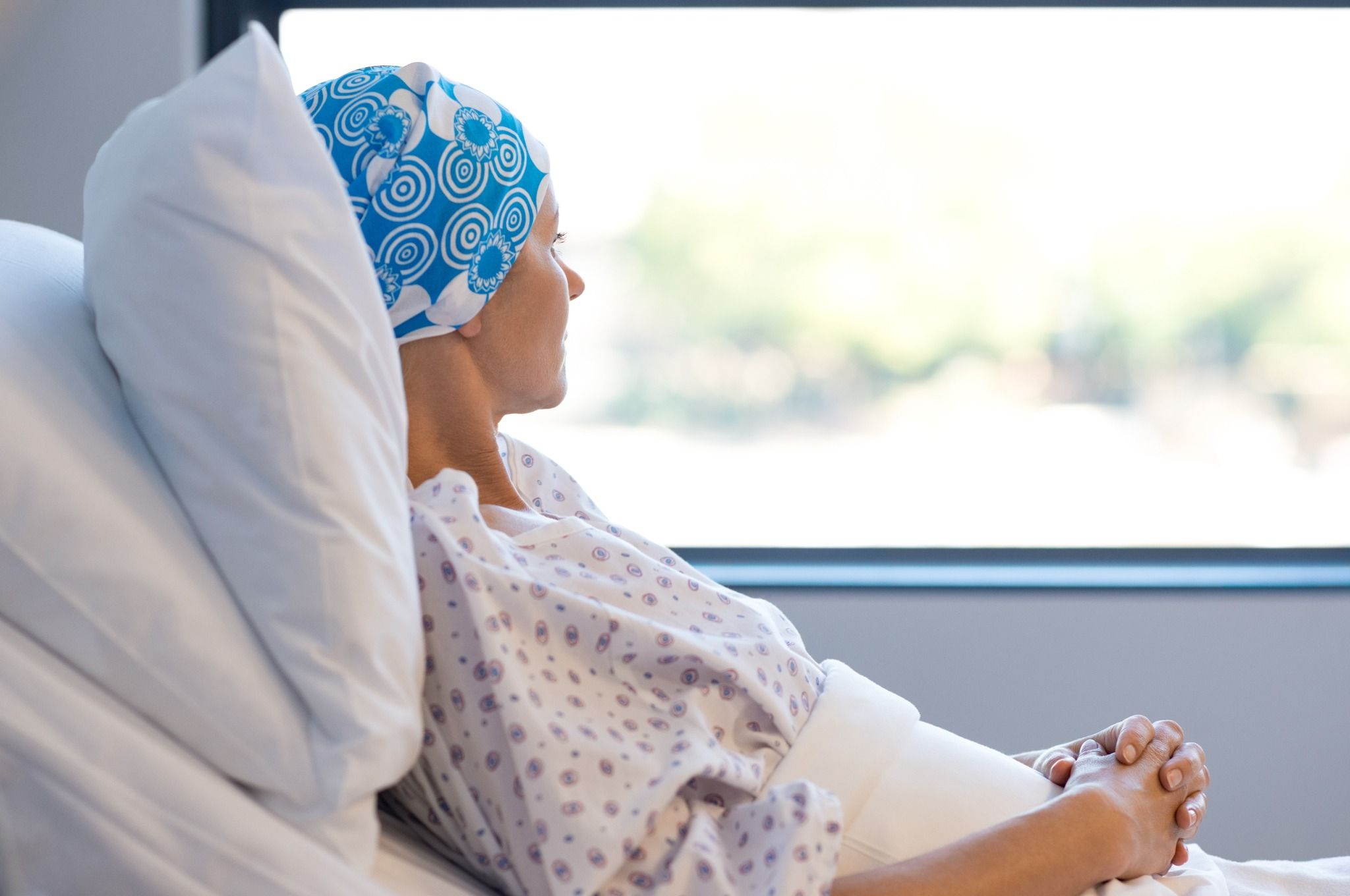 woman with cancer looking out a window